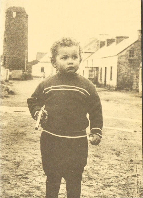 Photograph of a young boy with a gun taken from the cover of 'Tory Islands Darkest Hour"